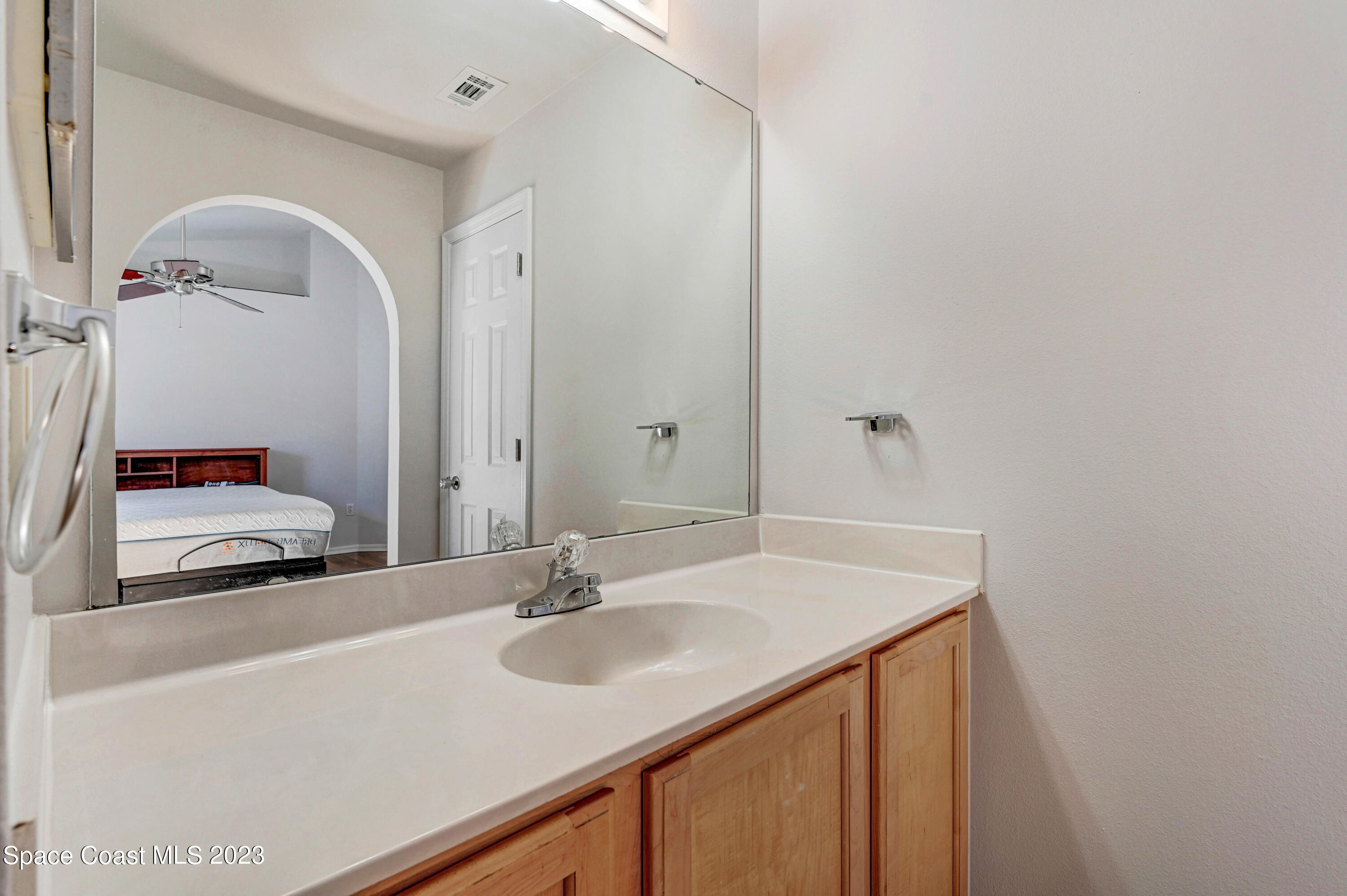 2070 Redwood Circle Palm Bay, FL 32905 - Photo 17 of 33 a bathroom with a sink and a mirror
