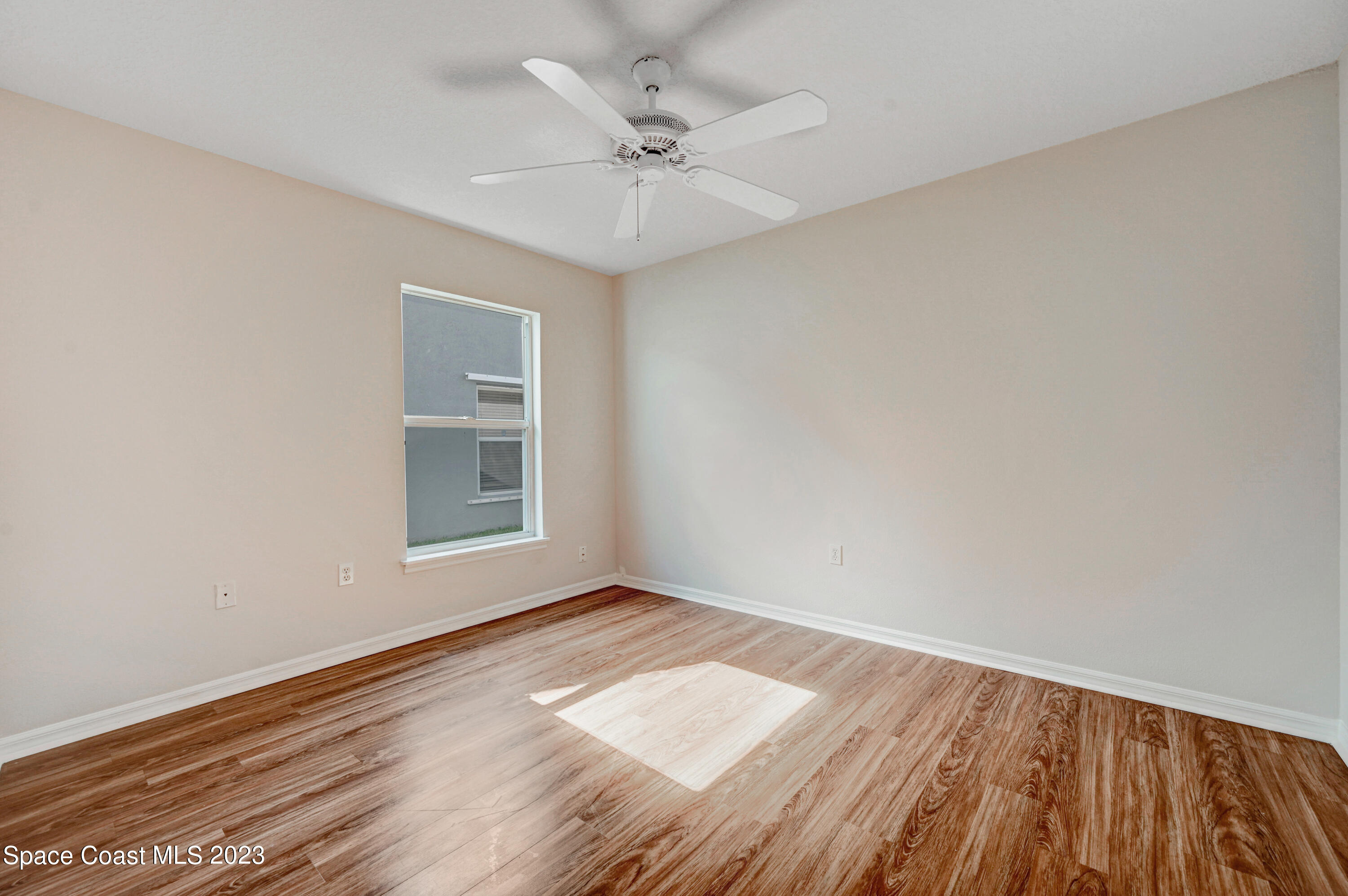 2070 Redwood Circle Palm Bay, FL 32905 - Photo 19 of 33 wooden floor in an empty room with a window