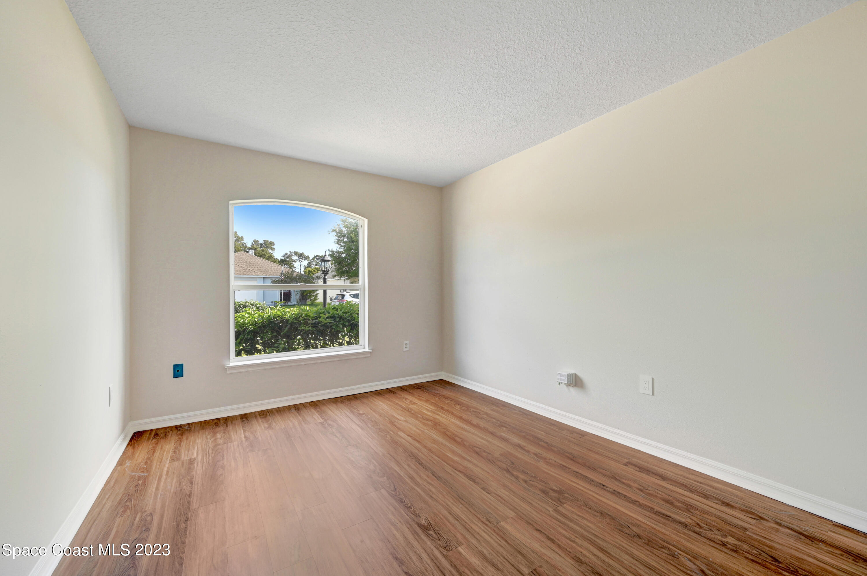 2070 Redwood Circle Palm Bay, FL 32905 - Photo 20 of 33 an empty room with wooden floor and a window