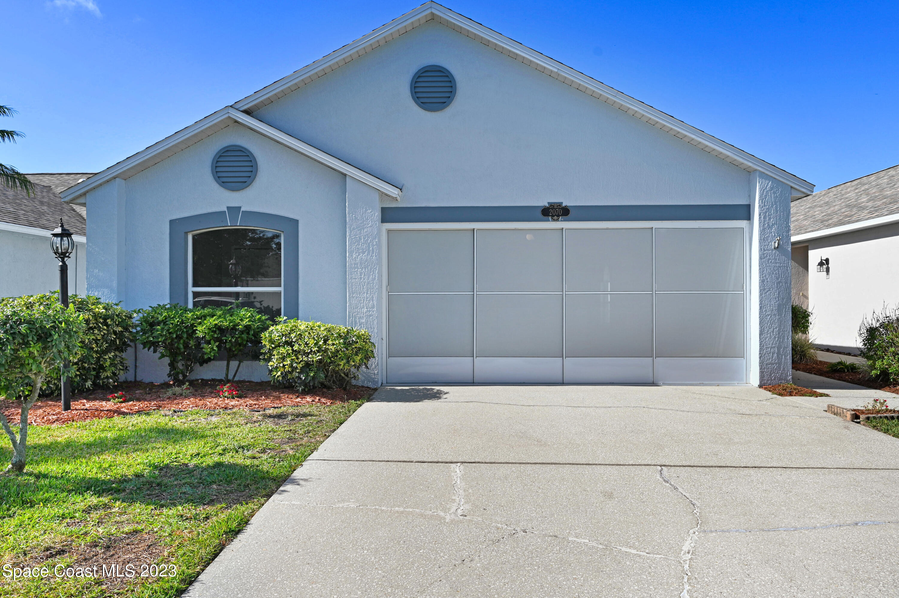 2070 Redwood Circle Palm Bay, FL 32905 - Photo 28 of 33 a front view of a house with a yard