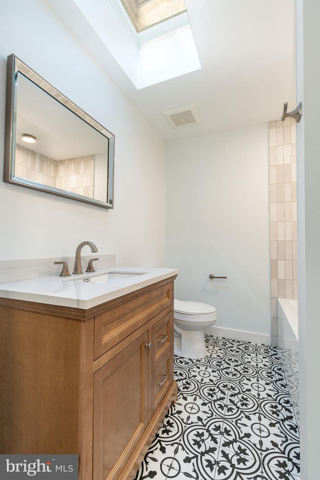 3016 South 17th Street Philadelphia, PA 19145 - Photo 15 of 30 a bathroom with a granite countertop sink a toilet and a mirror