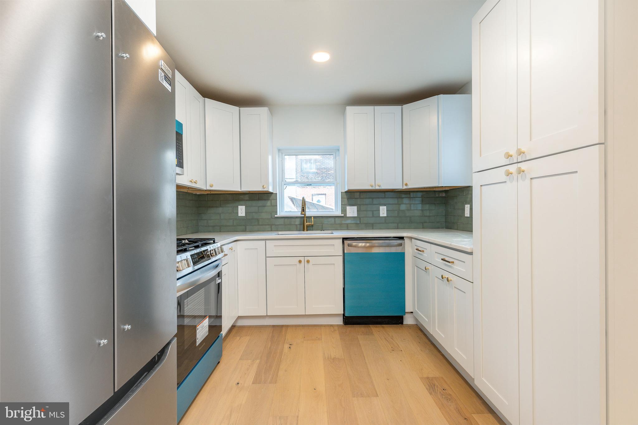 3016 South 17th Street Philadelphia, PA 19145 - Photo 5 of 30 a kitchen with granite countertop cabinets stainless steel appliances and a sink