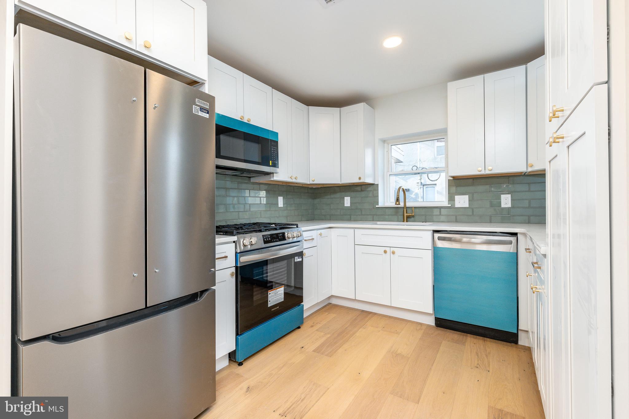 3016 South 17th Street Philadelphia, PA 19145 - Photo 6 of 30 a kitchen with a sink cabinets stainless steel appliances and a refrigerator