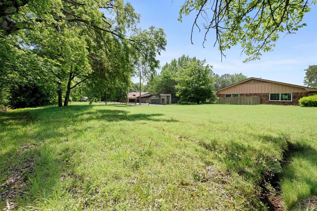 602 Wes Michael Road Bonham, TX 75418 - Photo 16 of 16 a view of a big yard with plants and large trees