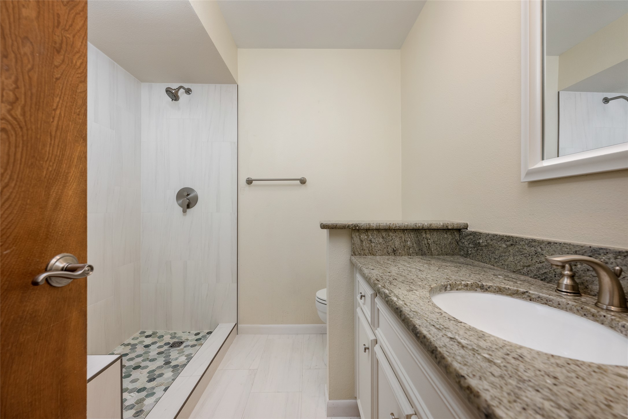 5319 Musket Ridge Austin, TX 78759 - Photo 28 of 39 A well-appointed bathroom features a spacious walk-in shower and elegant granite countertops.