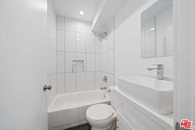 a bathroom with a sink a toilet and a bathtub