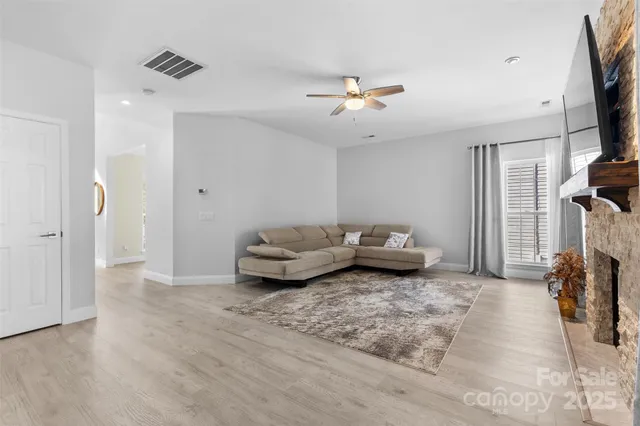 a kitchen with a refrigerator a oven and white cabinets