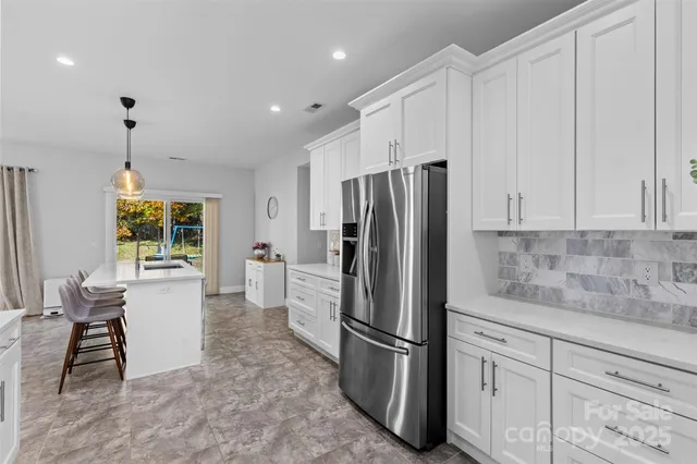 a view of a kitchen with a dining table and chairs