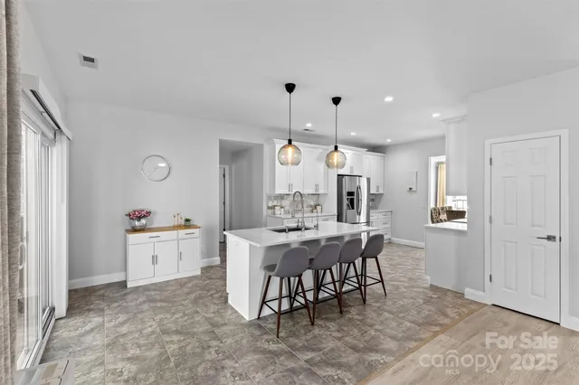 a white bath tub sitting in a bathroom next to a window