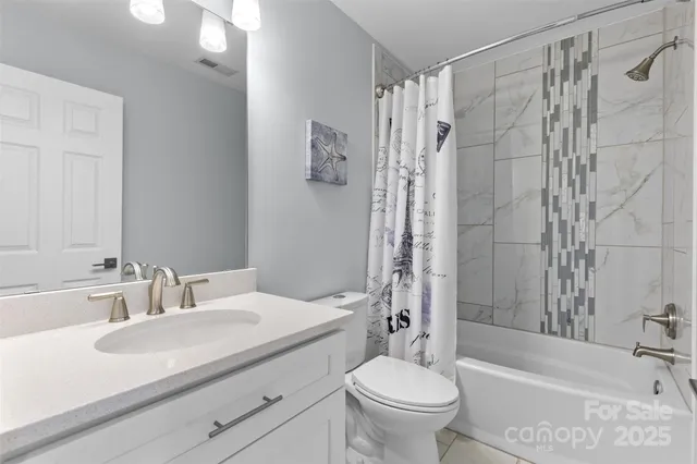 a view of a house with large windows and a big yard