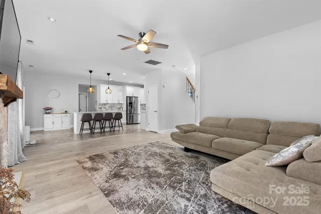 a living room with furniture fireplace and flat screen tv