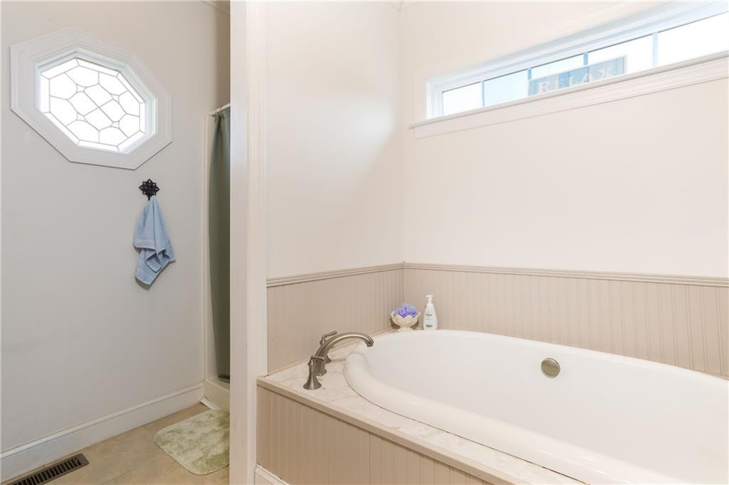 1008 Guerrant Springs Road Ruffin, NC 27326 - Photo 21 of 32 a bathroom with a white tub and a window