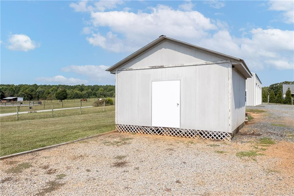 1008 Guerrant Springs Road Ruffin, NC 27326 - Photo 29 of 32 a view of a wooden house with a yard