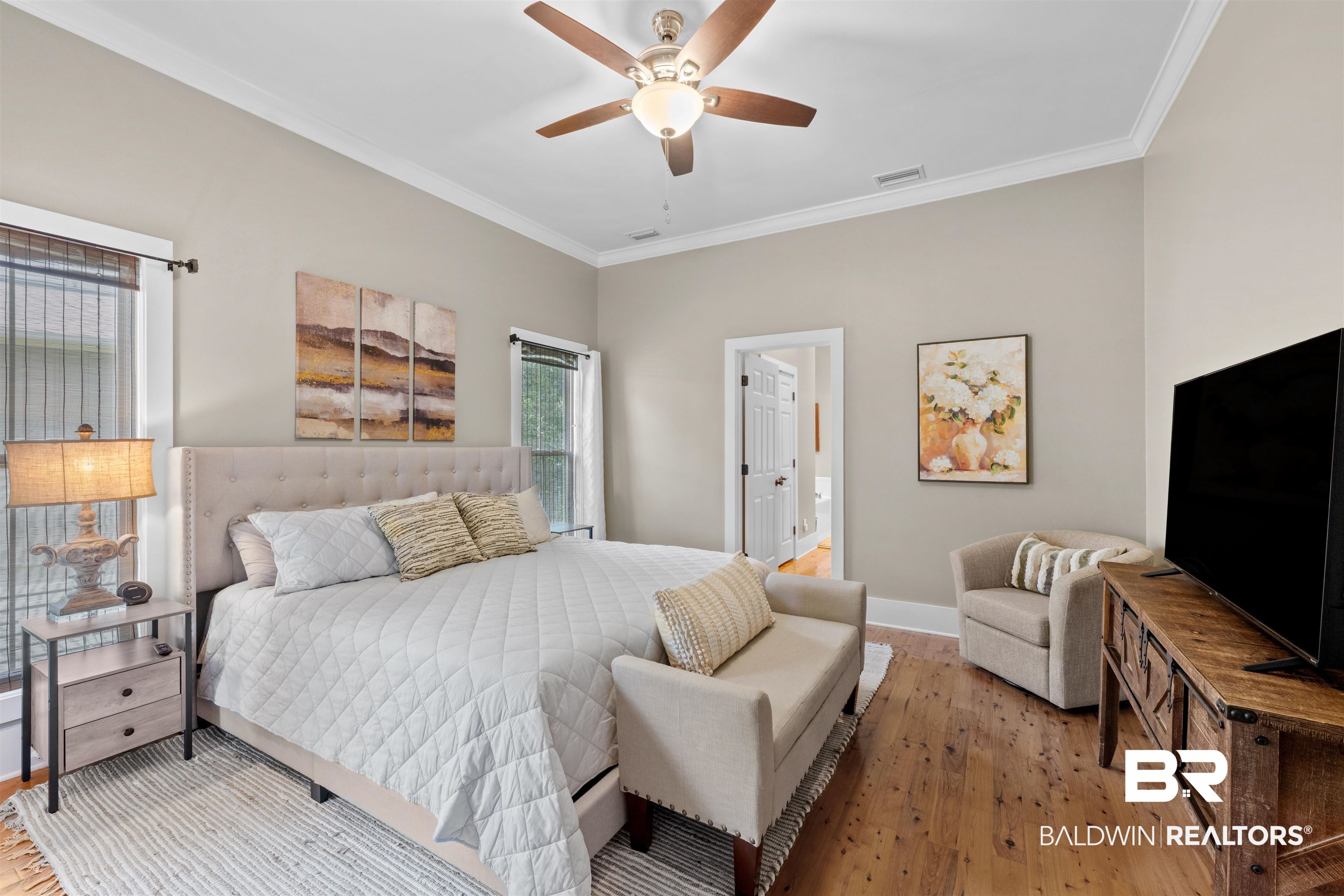 32700 Steelwood Ridge Road, Unit D Loxley, AL 36551 - Photo 12 of 41 Spacious room featuring hardwood flooring, crown molding, a ceiling fan, and two windows with blinds