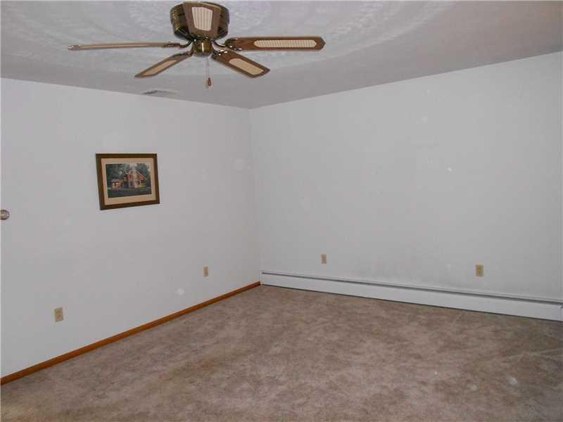 Living Room. Large living room with abundant natural lighting and newer carpeting.