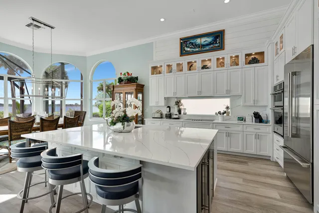 a view of a dining room with furniture water view and a chandelier