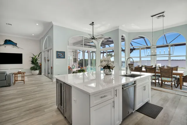 a bedroom with a large bed and a flat tv screen on dresser