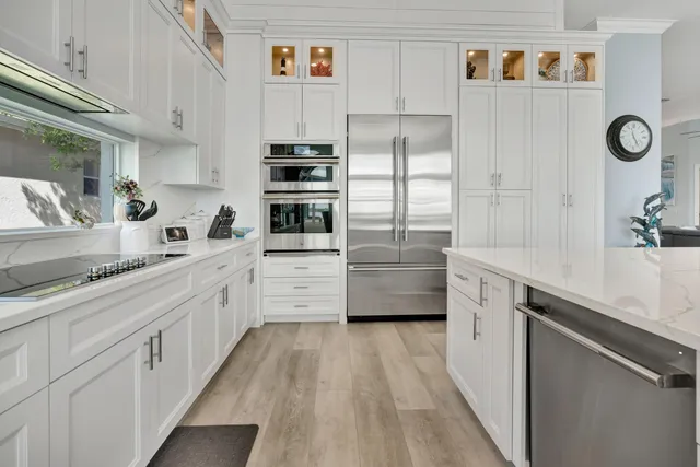 a spacious bedroom with a bed and a flat screen tv