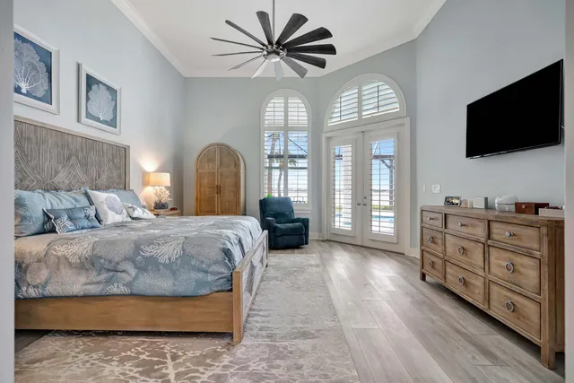 a living room with patio furniture and floor to ceiling windows