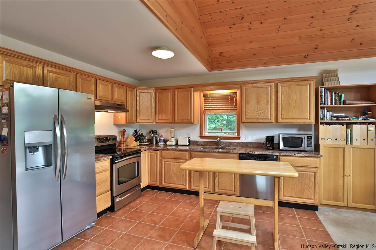 293 Barley Road Pine Hill, NY 12465 - Photo 16 of 25 a kitchen with stainless steel appliances granite countertop a stove top oven a sink dishwasher a refrigerator and cabinets with wooden floor