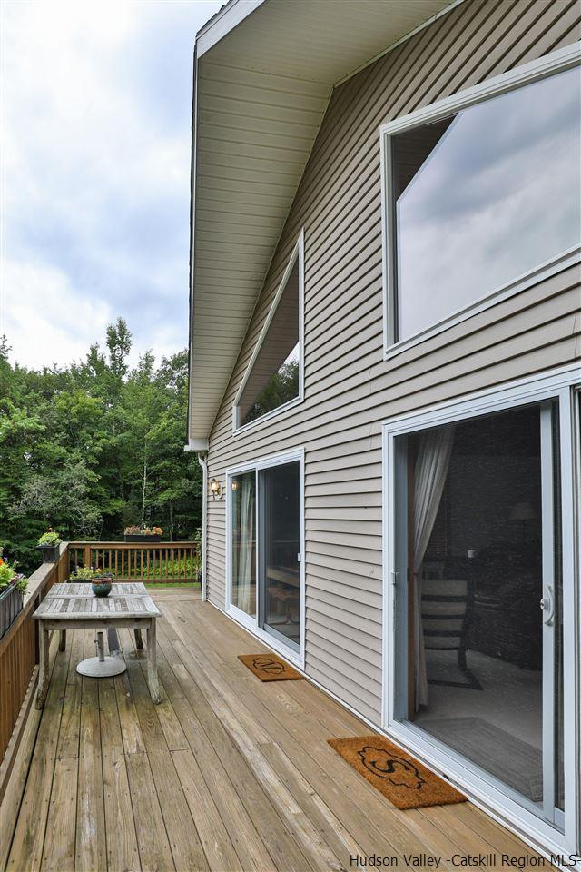 293 Barley Road Pine Hill, NY 12465 - Photo 7 of 25 a balcony with a bench and potted plants