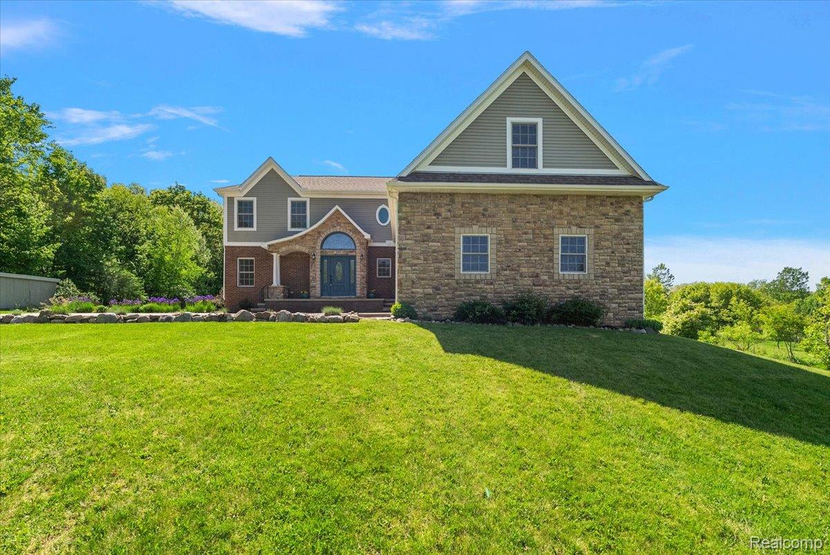 5035 Hidden Ridge Road Metamora, MI 48455 - Photo 65 of 65 Expansive front lawn leading to a stone and siding exterior