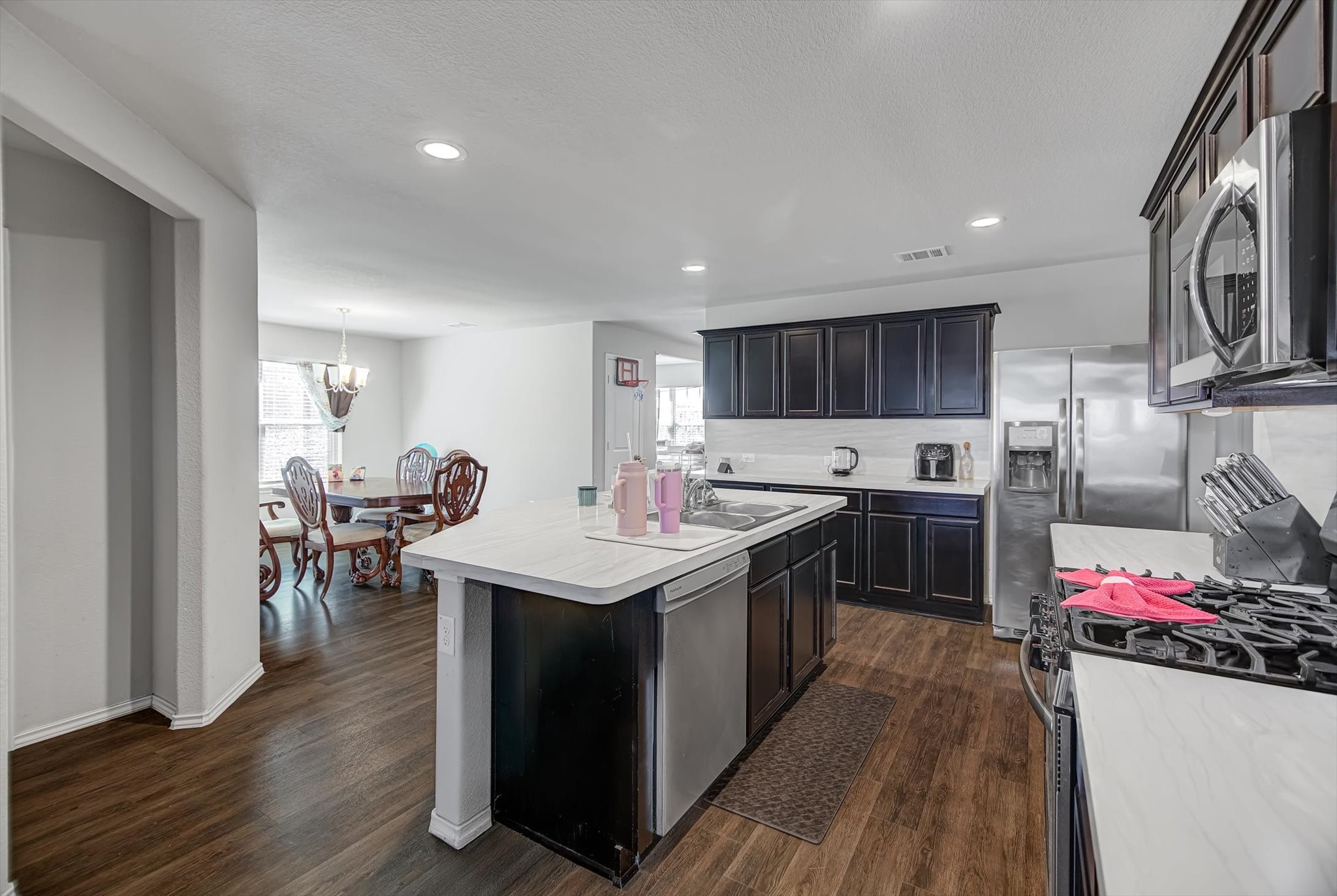 1230 Baja Vista Way Channelview, TX 77530 - Photo 11 of 33 a kitchen with stainless steel appliances granite countertop a stove top oven a sink dishwasher and a refrigerator with wooden floor