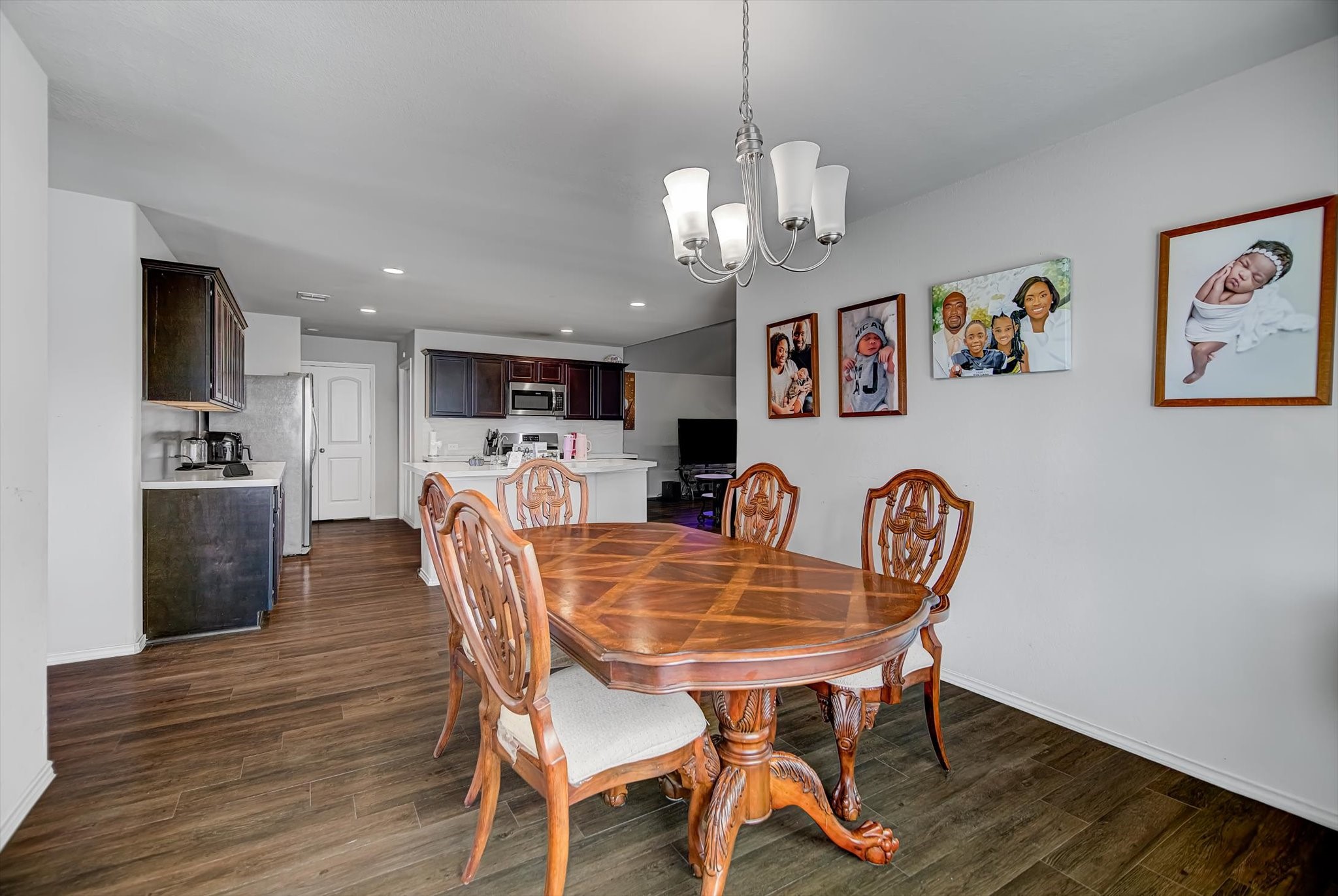 1230 Baja Vista Way Channelview, TX 77530 - Photo 15 of 33 a view of a dining room with furniture wooden floor and a chandelier