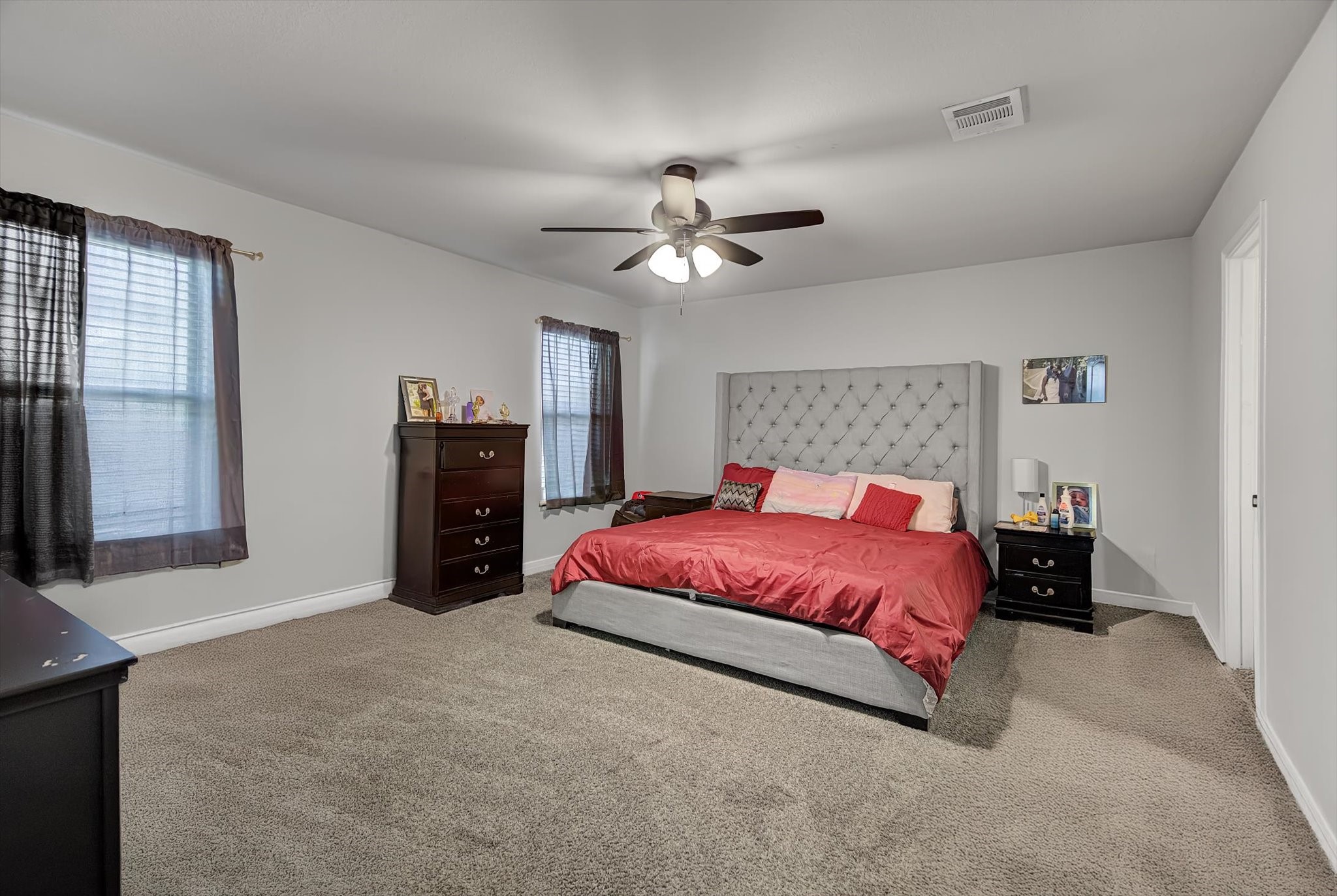 1230 Baja Vista Way Channelview, TX 77530 - Photo 16 of 33 a spacious bedroom with a bed and a chandelier