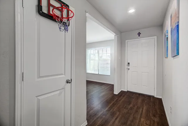a view of an entryway with wooden floor