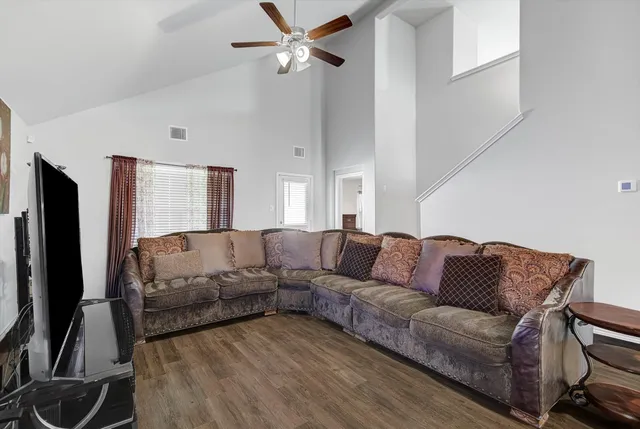 a living room with furniture ceiling fan and a rug