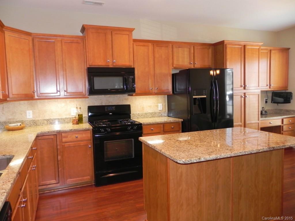 3030 Voyageurs Way Indian Land, SC 29707 - Photo 4 of 12 a kitchen with granite countertop a refrigerator stove and oven