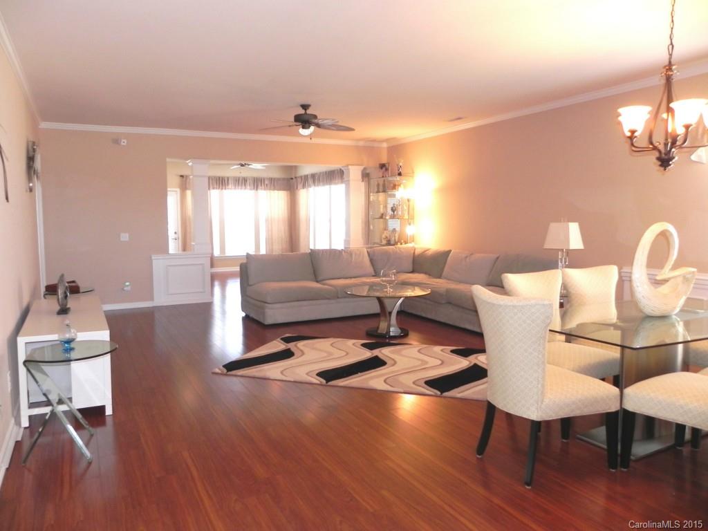 3030 Voyageurs Way Indian Land, SC 29707 - Photo 9 of 12 a living room with furniture a dining table and a large window