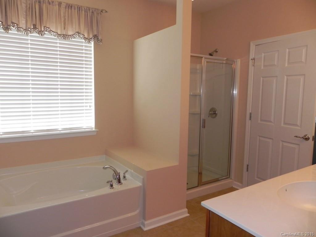 3030 Voyageurs Way Indian Land, SC 29707 - Photo 10 of 12 a bathroom with a bathtub and a shower