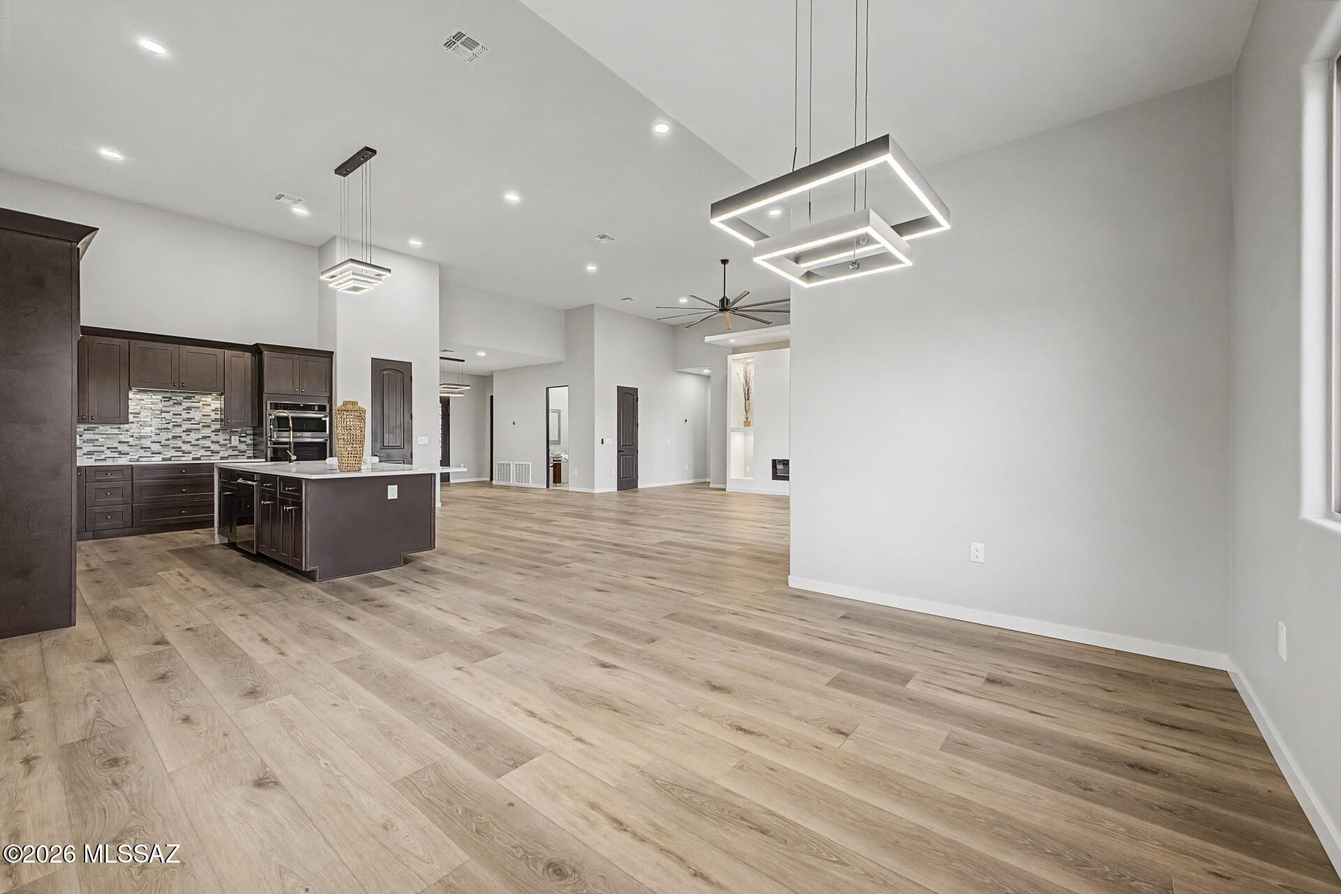 2399 Della Roccia Court Tucson, AZ 85737 - Photo 9 of 34 a view of kitchen and kitchen with furniture wooden floor