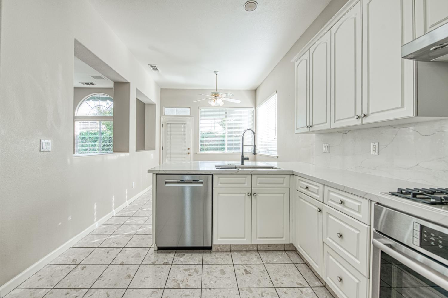2140 West Rue St Michel Fresno, CA 93711 - Photo 20 of 36 a kitchen with granite countertop white cabinets white appliances with a sink and dishwasher