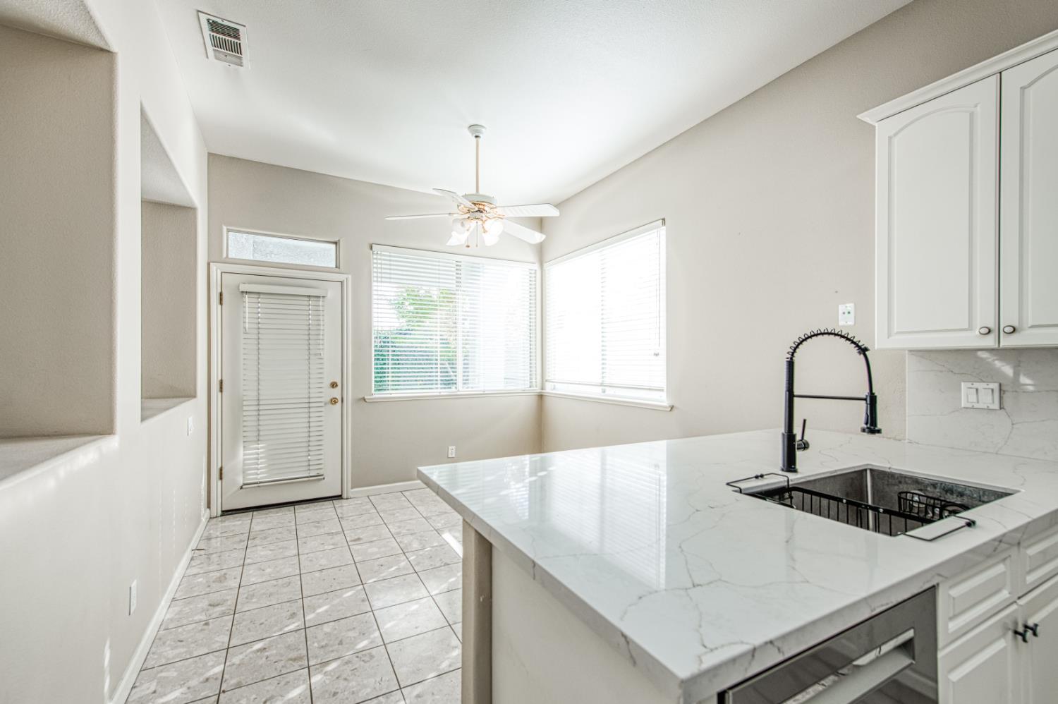 2140 West Rue St Michel Fresno, CA 93711 - Photo 23 of 36 a kitchen with a sink a stove and cabinets