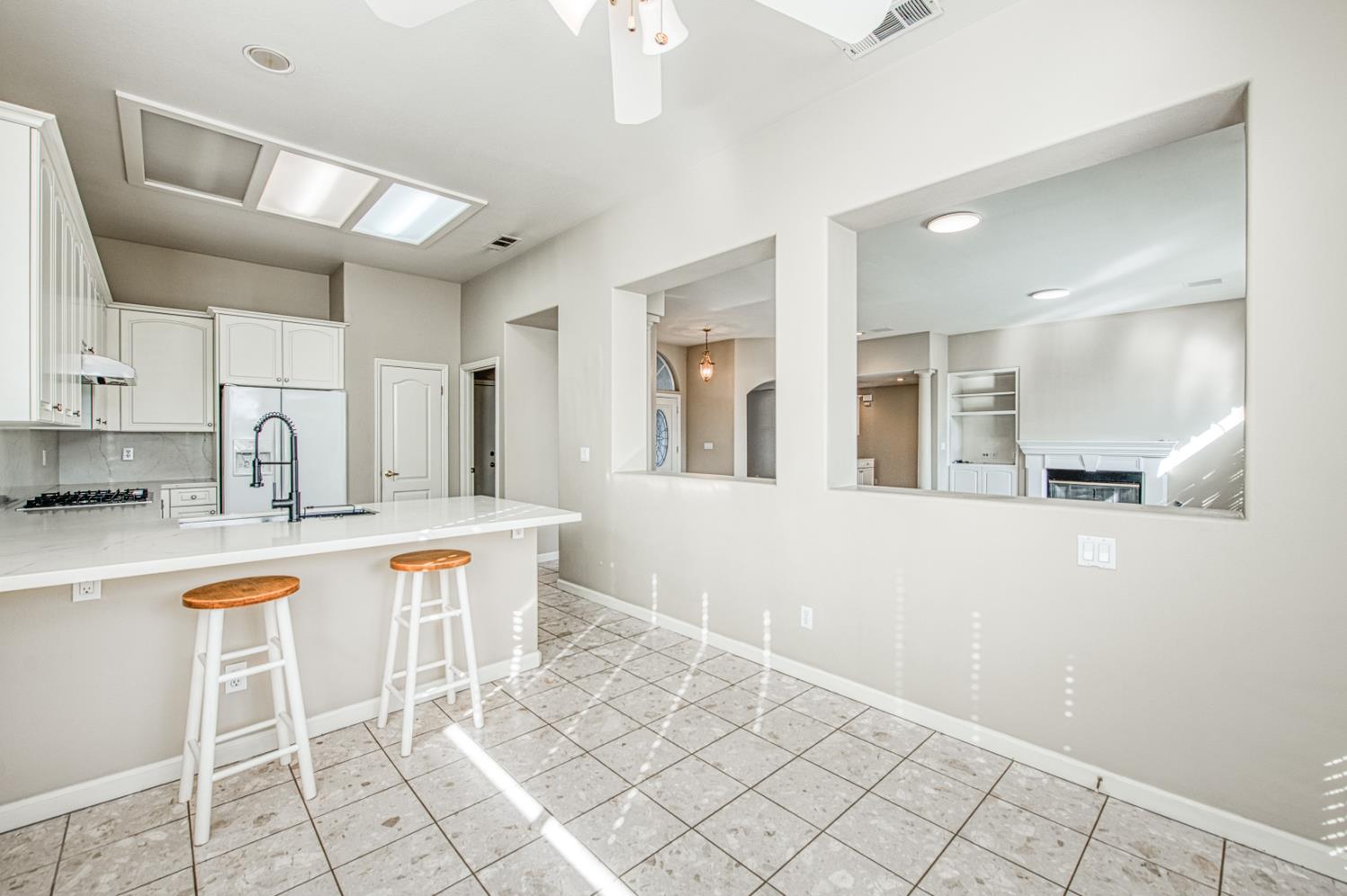 2140 West Rue St Michel Fresno, CA 93711 - Photo 25 of 36 a kitchen with stainless steel appliances granite countertop a sink and a refrigerator