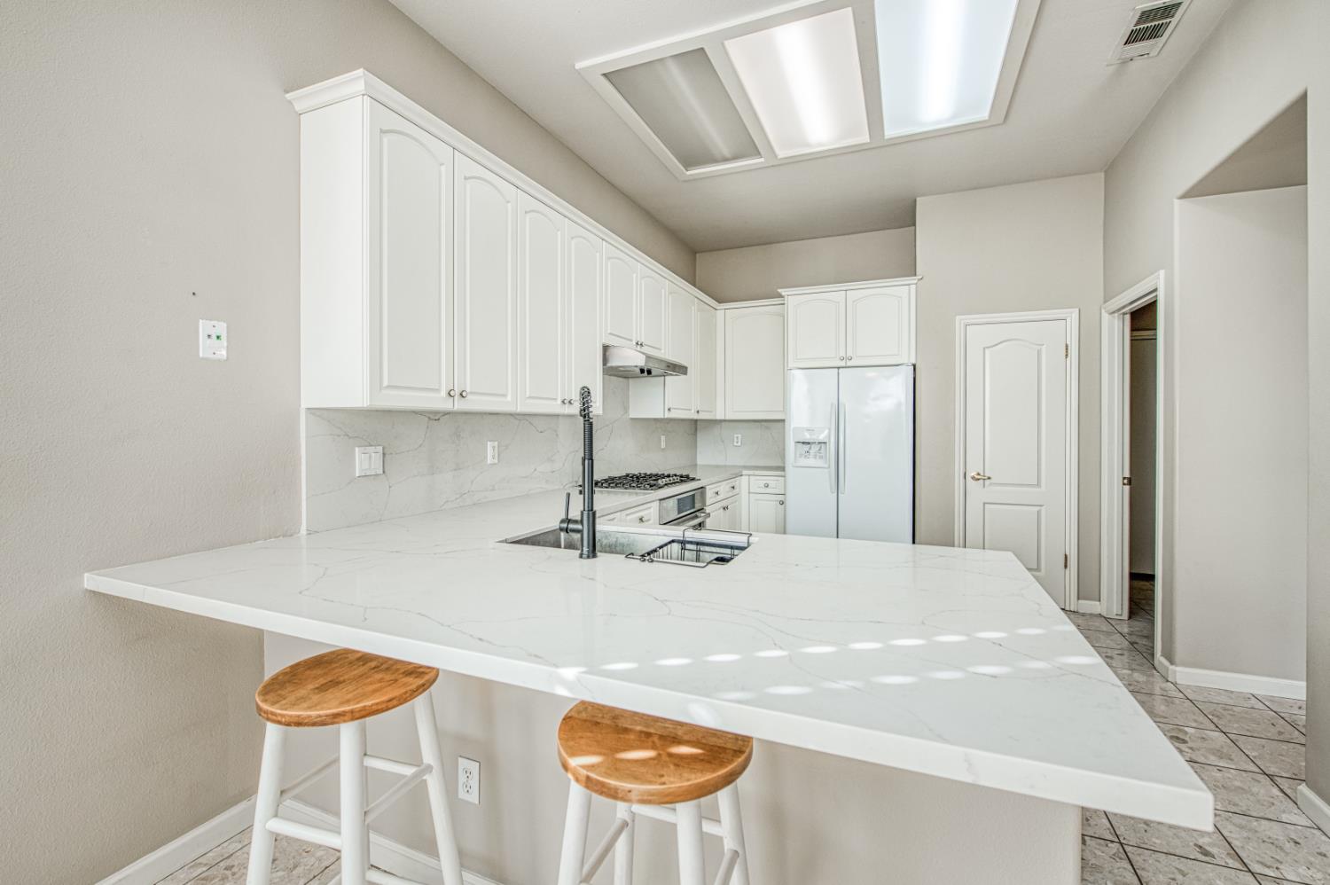 2140 West Rue St Michel Fresno, CA 93711 - Photo 26 of 36 a kitchen with stainless steel appliances granite countertop a sink a stove and a refrigerator