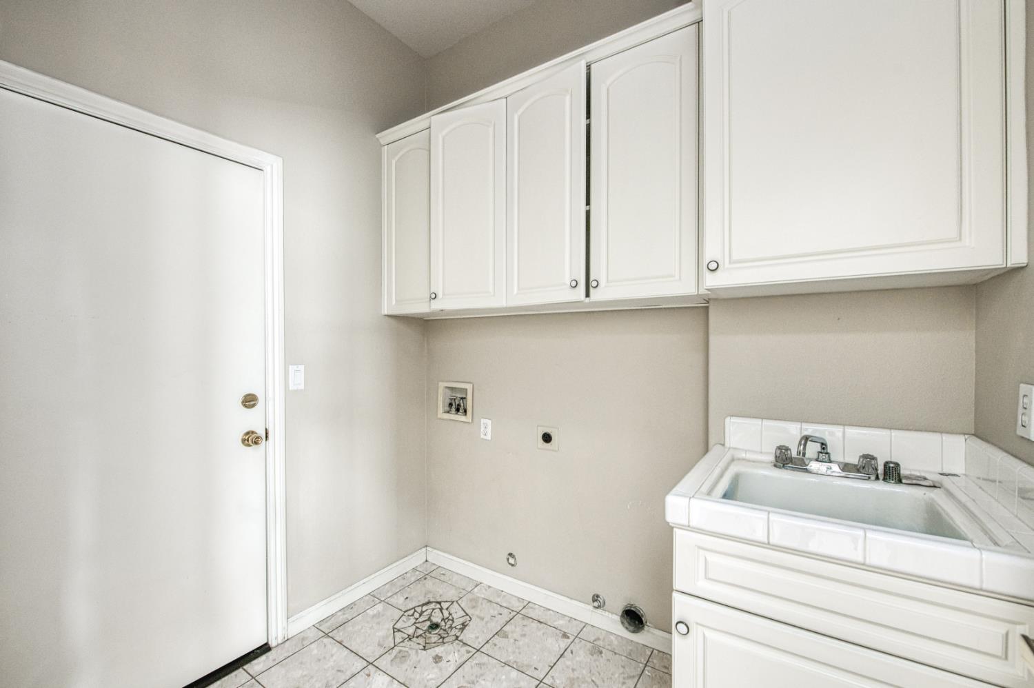 2140 West Rue St Michel Fresno, CA 93711 - Photo 28 of 36 a bathroom with a sink and cabinets