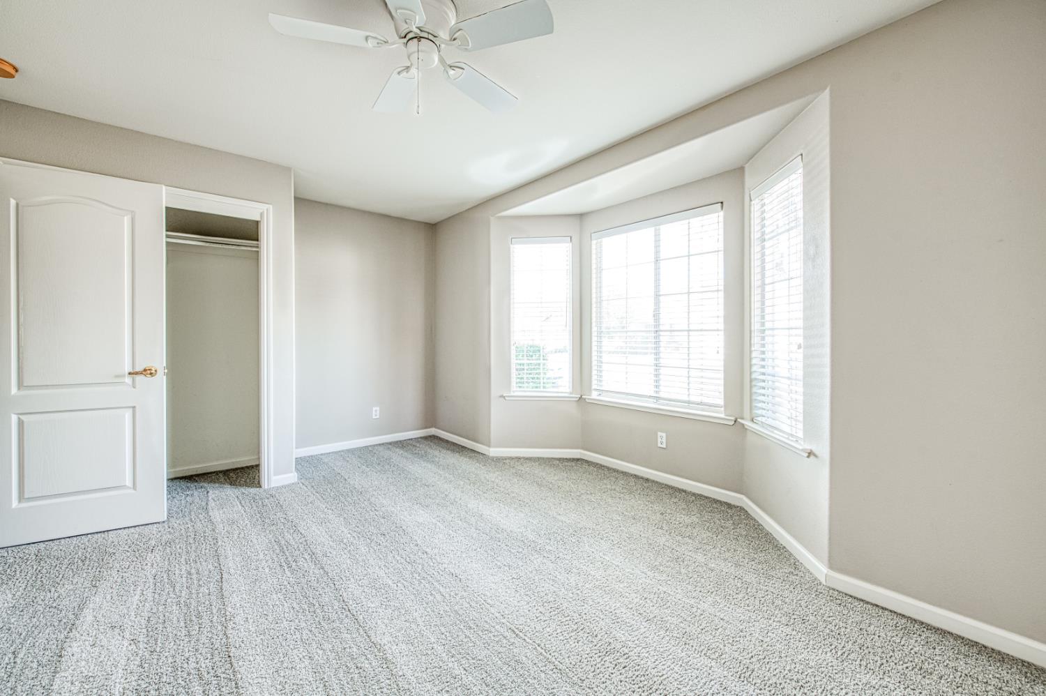 2140 West Rue St Michel Fresno, CA 93711 - Photo 31 of 36 wooden floor in an empty room with a window