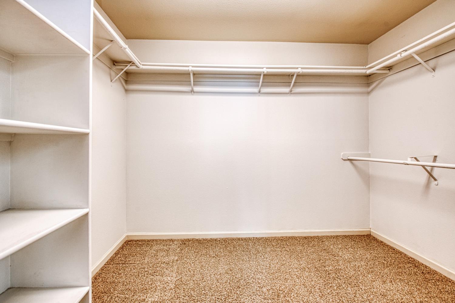 2140 West Rue St Michel Fresno, CA 93711 - Photo 35 of 36 a view of walk in closet with empty racks