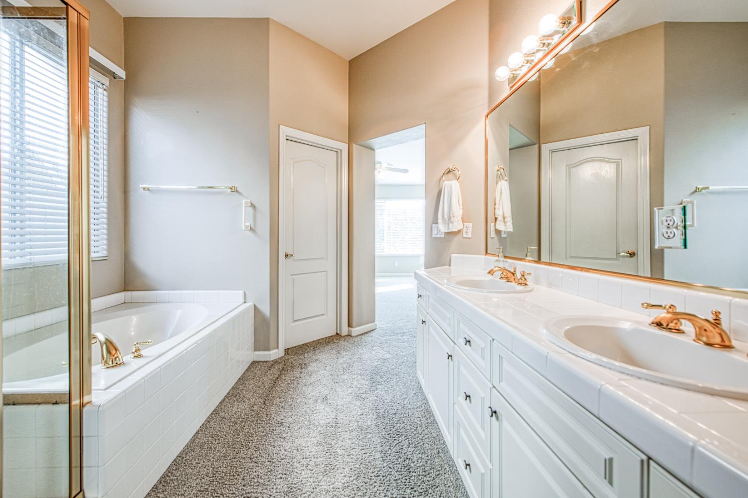 2140 West Rue St Michel Fresno, CA 93711 - Photo 36 of 36 a bathroom with a tub a sink and a large mirror