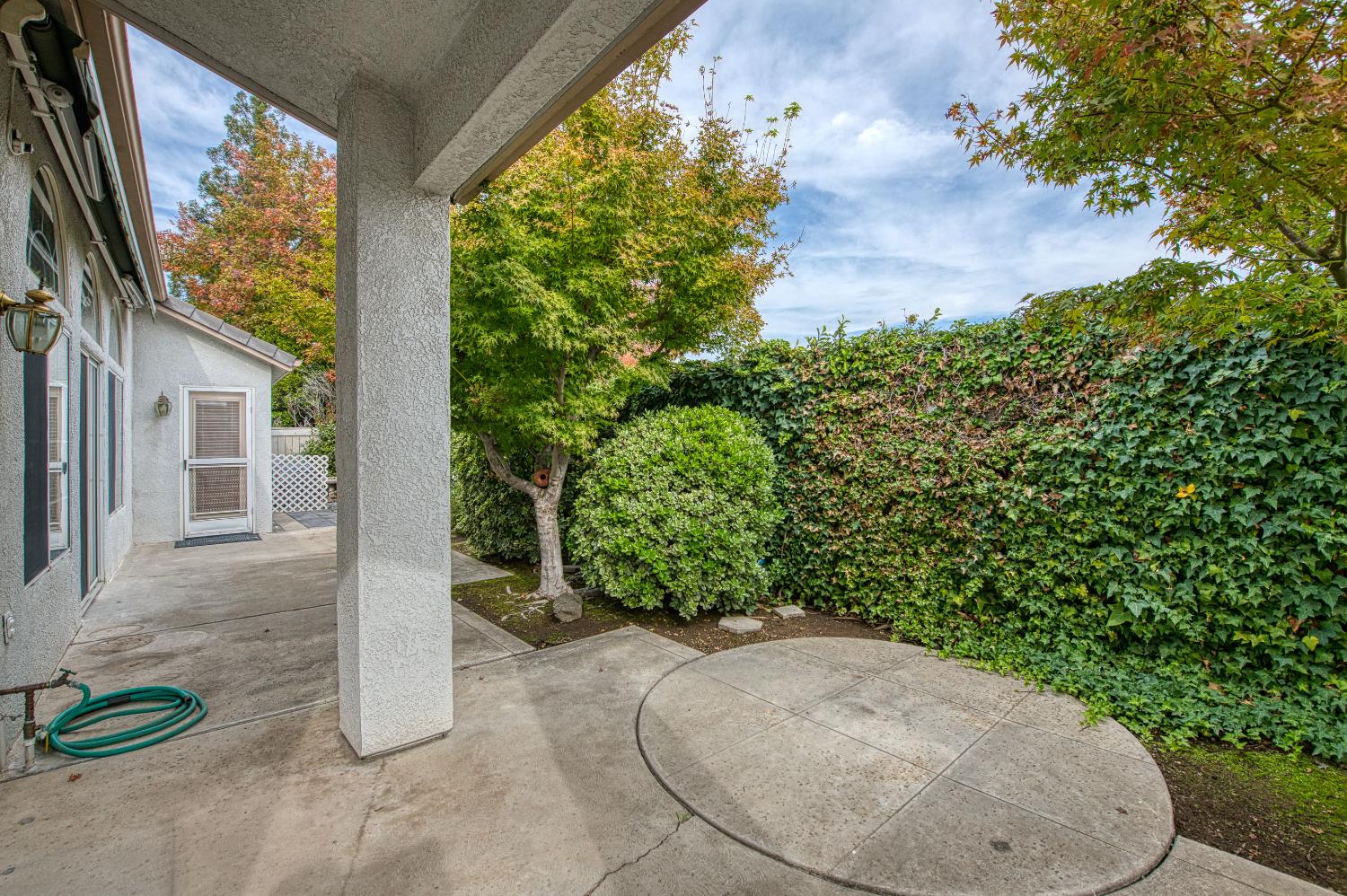 2140 West Rue St Michel Fresno, CA 93711 - Photo 6 of 36 a view of a backyard with plants and a garden