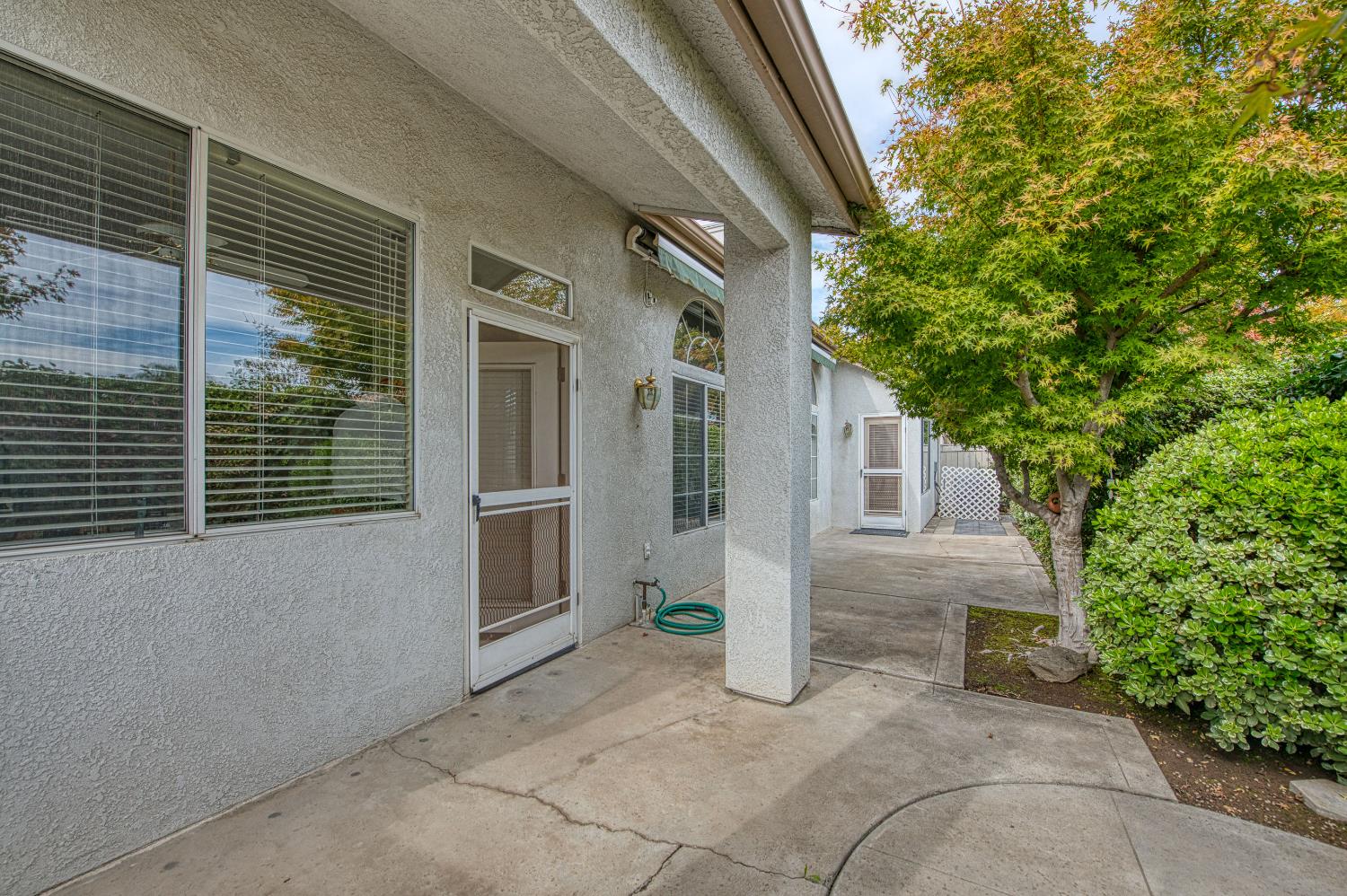 2140 West Rue St Michel Fresno, CA 93711 - Photo 7 of 36 a view of a house with a yard and potted plants