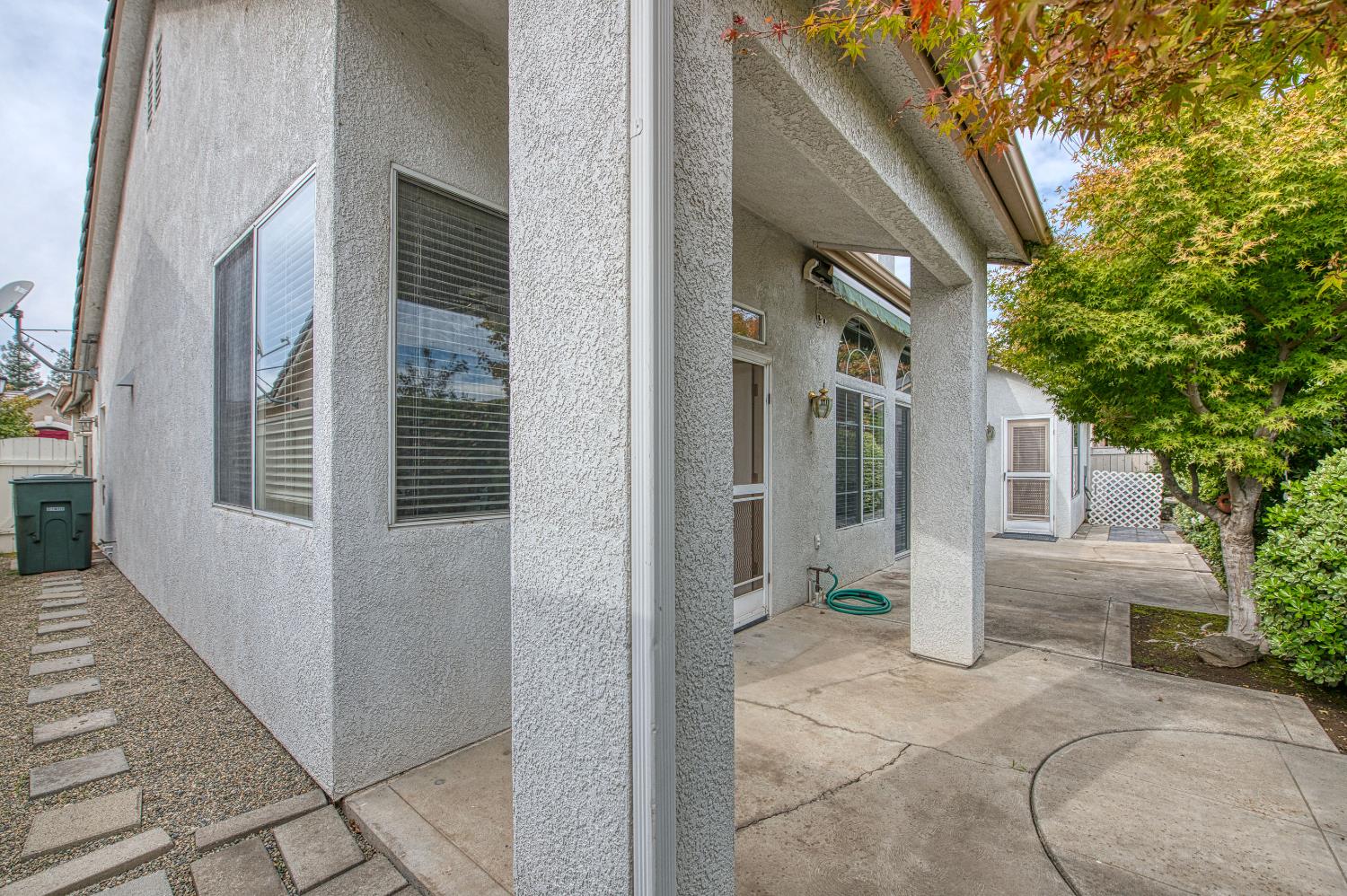 2140 West Rue St Michel Fresno, CA 93711 - Photo 8 of 36 a view of a house with backyard and glass windows