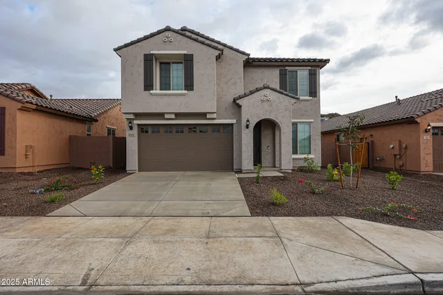 a front view of a house with a yard and garage