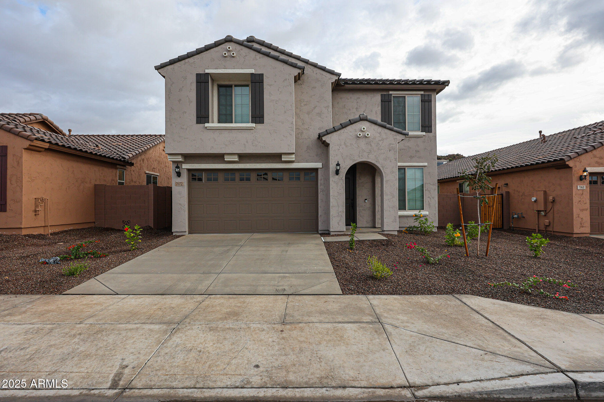 a front view of a house with a yard and garage