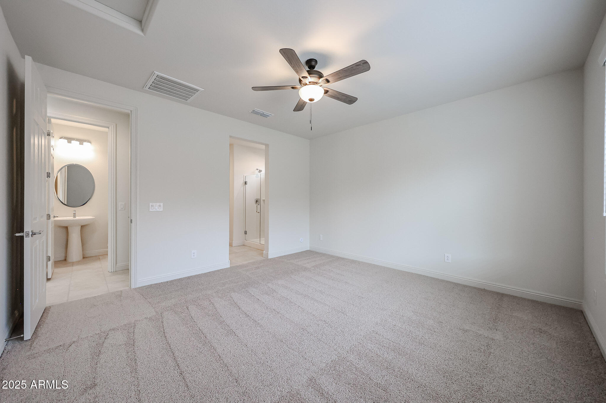 7072 West Oberlin Way Peoria, AZ 85383 - Photo 11 of 24 wooden floor in an empty room and a bathroom