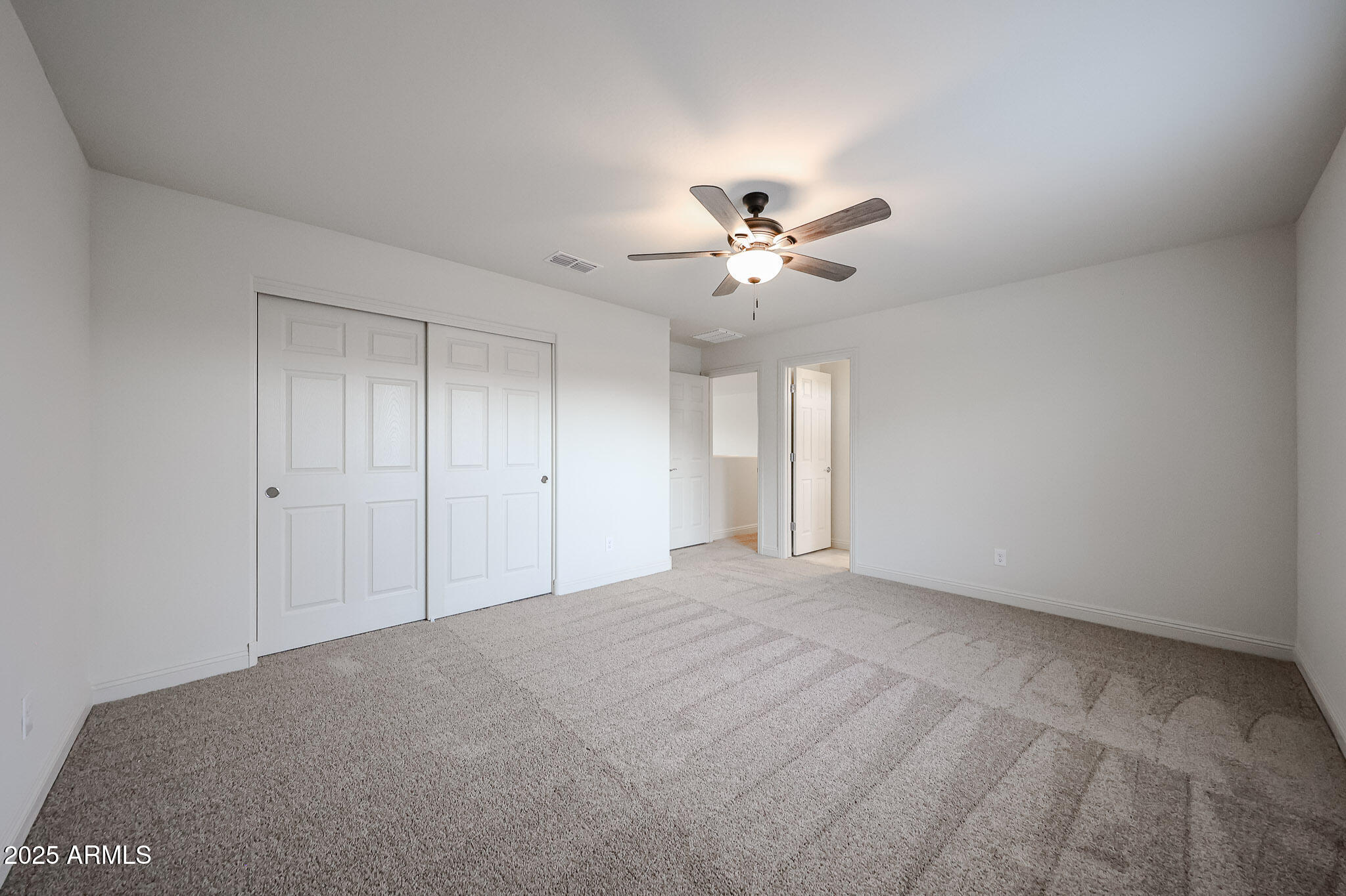 7072 West Oberlin Way Peoria, AZ 85383 - Photo 16 of 24 a view of an empty room with a chandelier fan